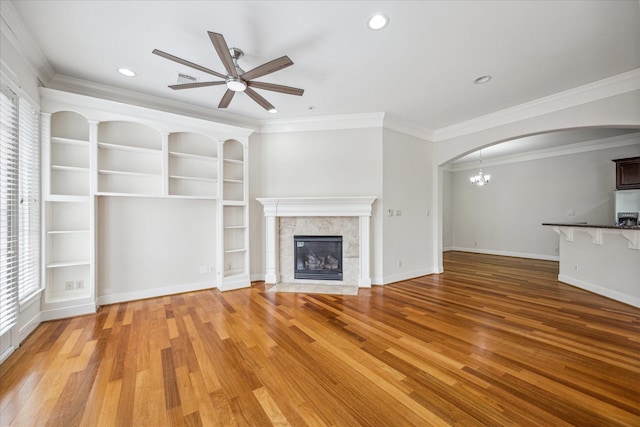 1316 Birdsall St, Houston, TX 77007 - unfurnished living room with arched walkways, ceiling fan, plenty of natural light, light wood-type flooring, and crown molding