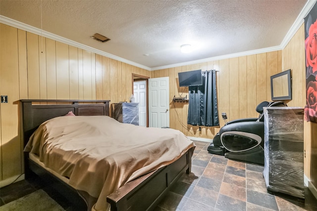 7528 Gainesville St, Houston, TX 77020 - bedroom with ornamental molding, a textured ceiling, stone finish flooring, and wooden walls