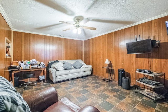 7528 Gainesville St, Houston, TX 77020 - living room with ceiling fan, ornamental molding, wood walls, a textured ceiling, and stone finish floors