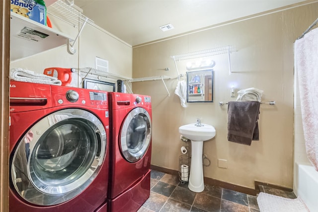 7528 Gainesville St, Houston, TX 77020 - washroom featuring washer and dryer and dark stone finish floors