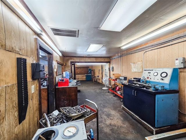 7528 Gainesville St, Houston, TX 77020 - misc room with concrete flooring, a workshop area, and wood walls
