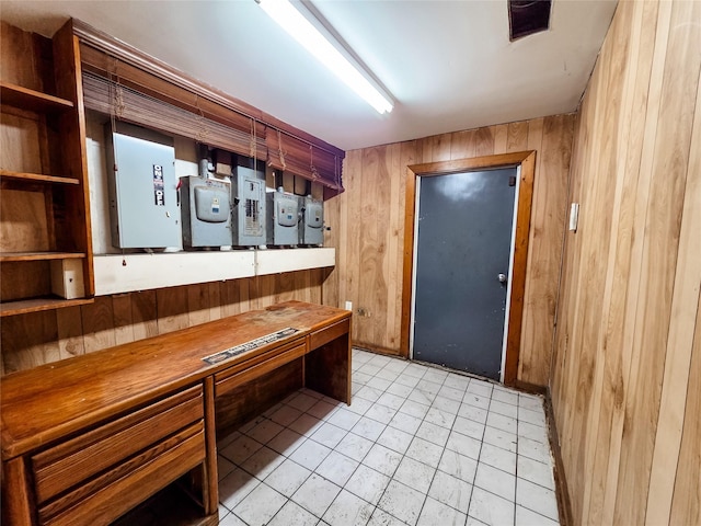 7528 Gainesville St, Houston, TX 77020 - entryway featuring electric panel, wooden walls, light tile patterned floors, and built in study area