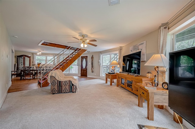22914 Whittaker Way, Spring, TX 77373 - living area with light carpet, stairs, and ceiling fan