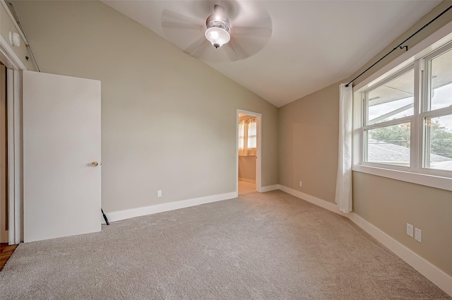 22914 Whittaker Way, Spring, TX 77373 - unfurnished bedroom featuring multiple windows, light colored carpet, vaulted ceiling, ceiling fan, and ensuite bath