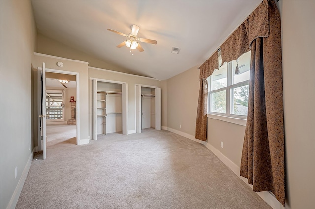 22914 Whittaker Way, Spring, TX 77373 - unfurnished bedroom with multiple closets, light carpet, lofted ceiling, and ceiling fan