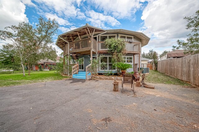 22914 Whittaker Way, Spring, TX 77373 - rear view of house with a balcony