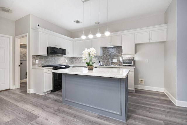 2032 Glencove Dr, Seabrook, TX 77586 - kitchen featuring black appliances, decorative backsplash, white cabinets, and wood finished floors