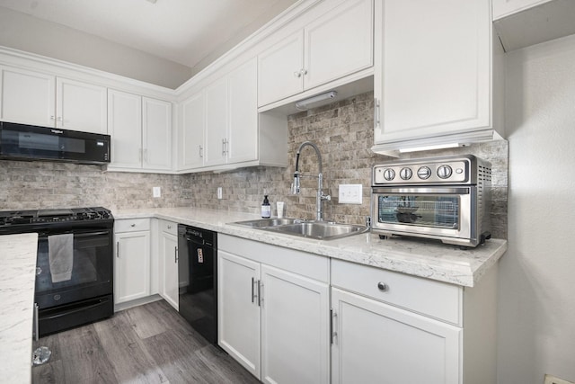 2032 Glencove Dr, Seabrook, TX 77586 - kitchen with black appliances, white cabinetry, decorative backsplash, and wood finished floors