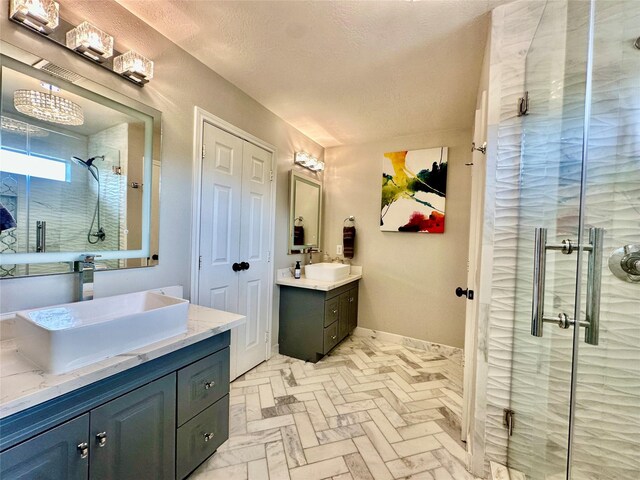 2032 Glencove Dr, Seabrook, TX 77586 - bathroom with two vanities, a shower stall, brick patterned floors, and a textured ceiling