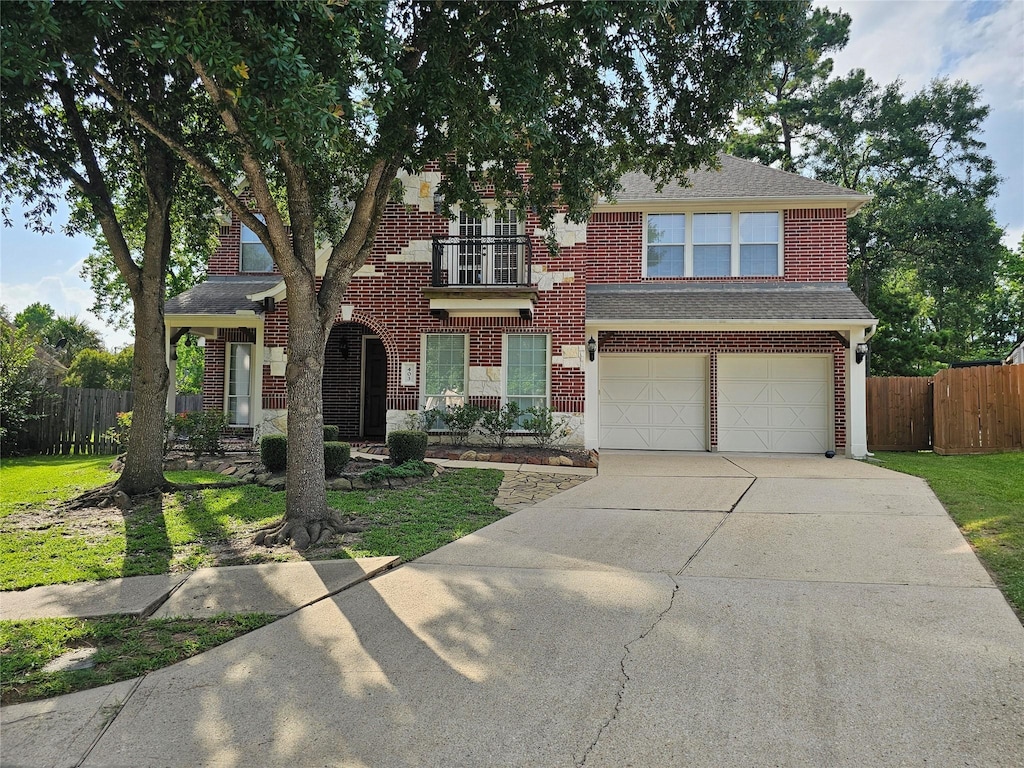 403 Woodpecker Forest Ln, Conroe, TX 77384 - view of front of home featuring concrete driveway, an attached garage, brick siding, and a shingled roof