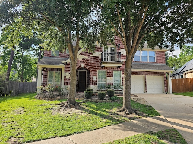 403 Woodpecker Forest Ln, Conroe, TX 77384 - view of front of home featuring a balcony, driveway, a garage, and brick siding