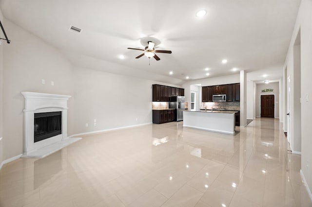 5107 Preserve Park Dr, Spring, TX 77389 - unfurnished living room featuring ceiling fan, recessed lighting, a fireplace with raised hearth, and light tile patterned flooring