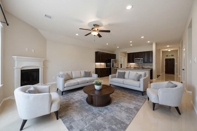 5107 Preserve Park Dr, Spring, TX 77389 - living area featuring a ceiling fan, a glass covered fireplace, recessed lighting, and light tile patterned flooring