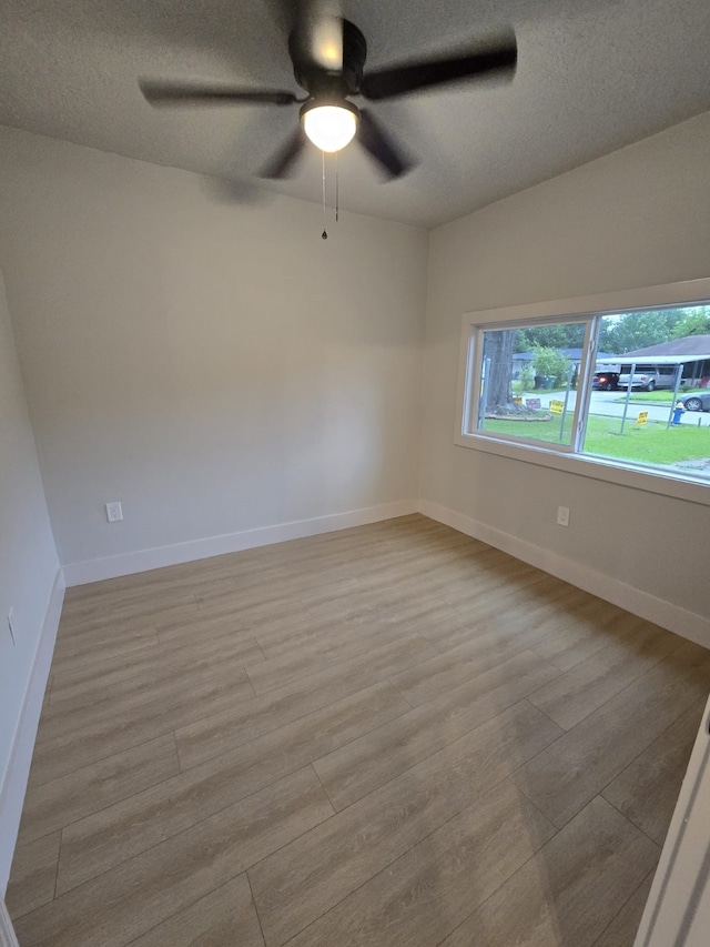 5326 Dewberry St, Houston, TX 77021 - spare room featuring wood finished floors, a ceiling fan, and a textured ceiling