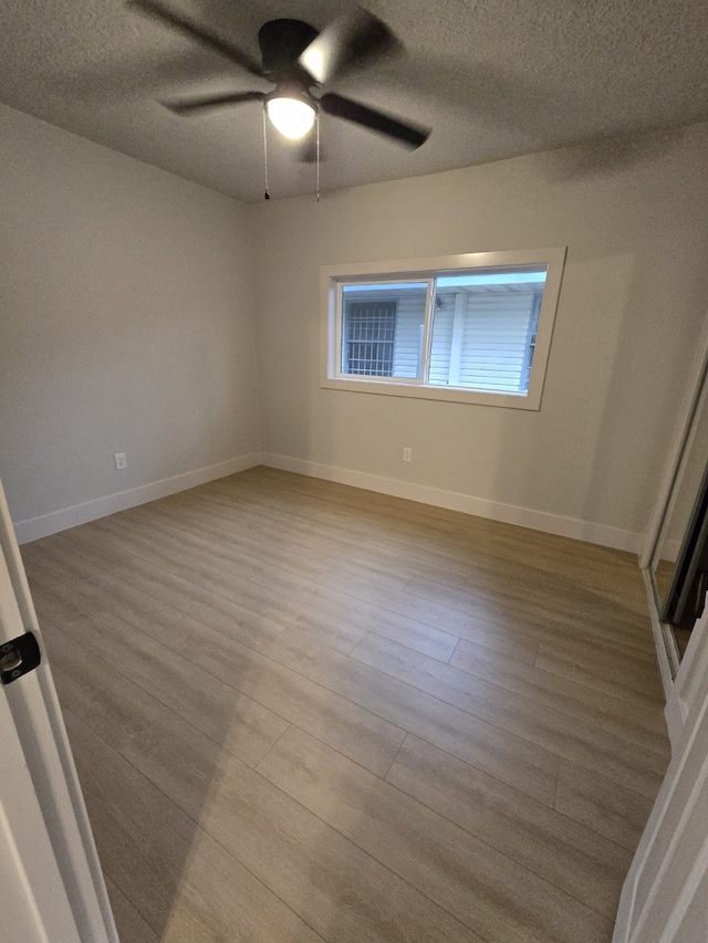 5326 Dewberry St, Houston, TX 77021 - empty room with wood finished floors, a ceiling fan, and a textured ceiling