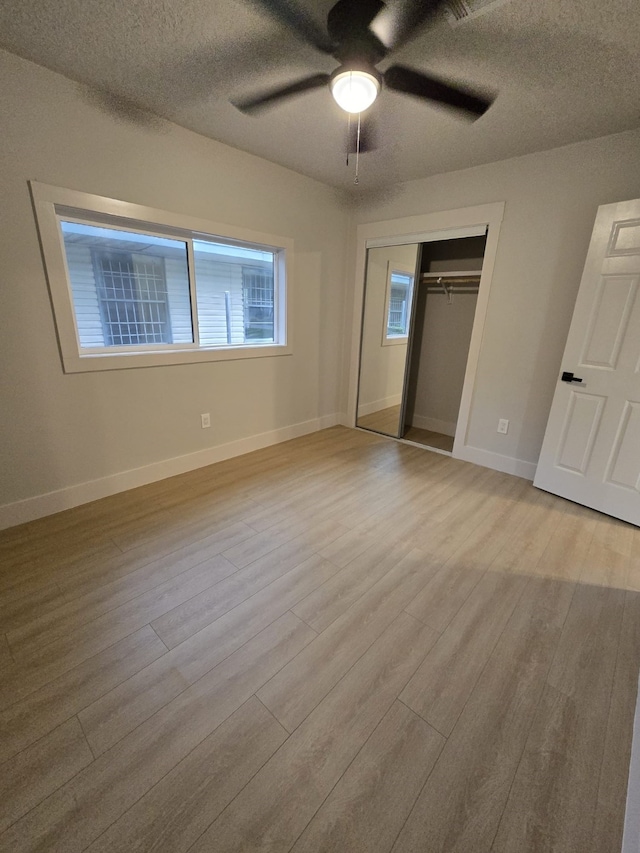 5326 Dewberry St, Houston, TX 77021 - unfurnished bedroom featuring wood finished floors, a closet, a textured ceiling, and ceiling fan