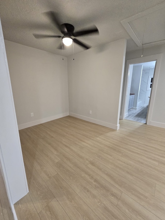5326 Dewberry St, Houston, TX 77021 - empty room featuring attic access, a ceiling fan, a textured ceiling, and light wood-type flooring