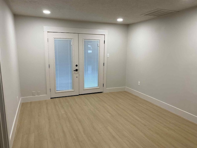 5326 Dewberry St, Houston, TX 77021 - entrance foyer with light wood-style flooring, french doors, recessed lighting, and a textured ceiling