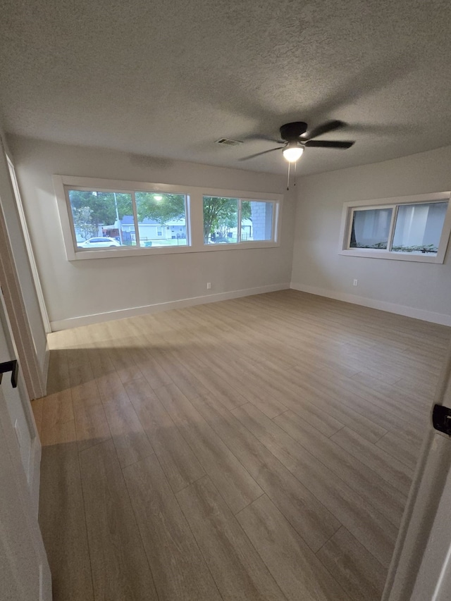 5326 Dewberry St, Houston, TX 77021 - empty room with wood finished floors, a textured ceiling, and ceiling fan