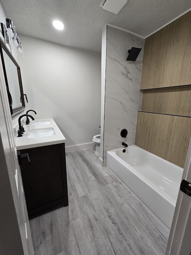 5326 Dewberry St, Houston, TX 77021 - full bath with a textured ceiling, double vanity, wood finished floors, and shower / bathtub combination