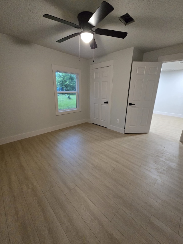 5326 Dewberry St, Houston, TX 77021 - unfurnished bedroom with wood finished floors, a textured ceiling, and a ceiling fan