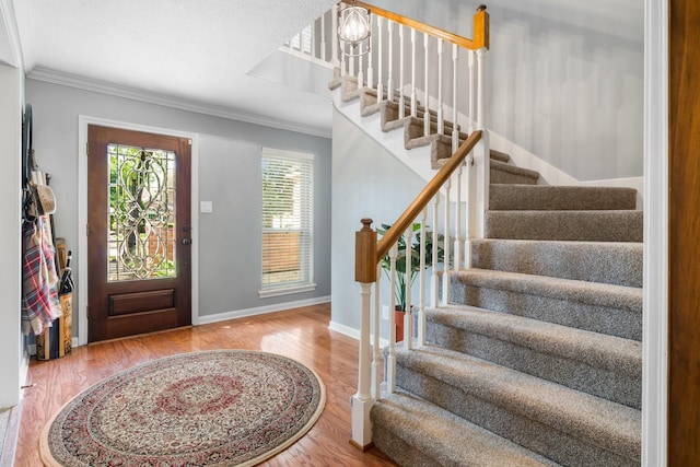 9611 Stockport Dr, Spring, TX 77379 - foyer entrance featuring ornamental molding, stairs, and wood finished floors
