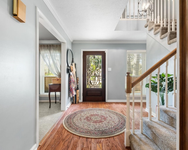 9611 Stockport Dr, Spring, TX 77379 - foyer with stairway, wood finished floors, and crown molding
