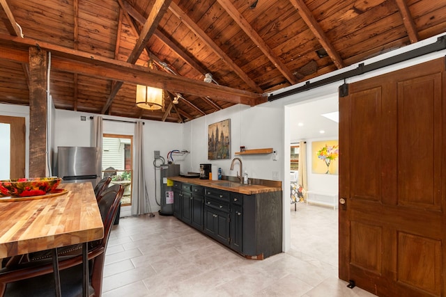 3809 Billingsley St, Houston, TX 77009 - kitchen featuring wooden counters, wooden ceiling, water heater, freestanding refrigerator, and light tile patterned floors