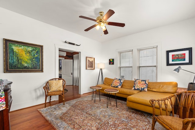 3809 Billingsley St, Houston, TX 77009 - living area with wood finished floors, a ceiling fan, and an AC wall unit