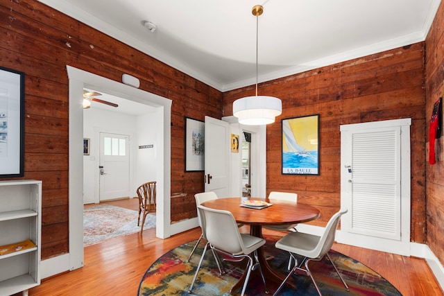 3809 Billingsley St, Houston, TX 77009 - dining area with wood walls, light wood-style floors, and a ceiling fan