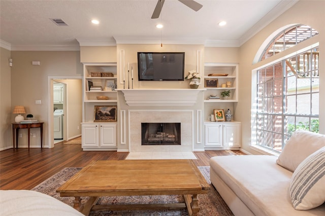 1907 Garden Fern Ct, Houston, TX 77062 - living area with wood finished floors, ceiling fan, washer / clothes dryer, ornamental molding, and a tile fireplace