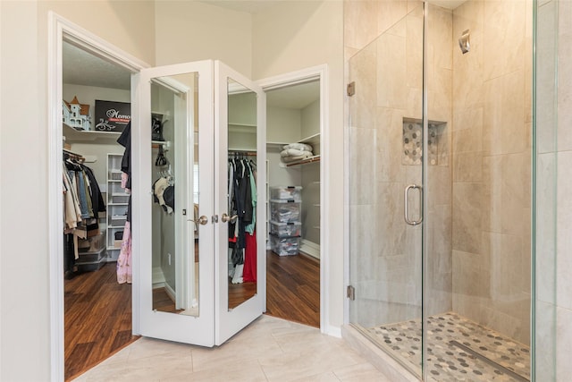 1907 Garden Fern Ct, Houston, TX 77062 - bathroom featuring a stall shower, a spacious closet, and tile patterned flooring