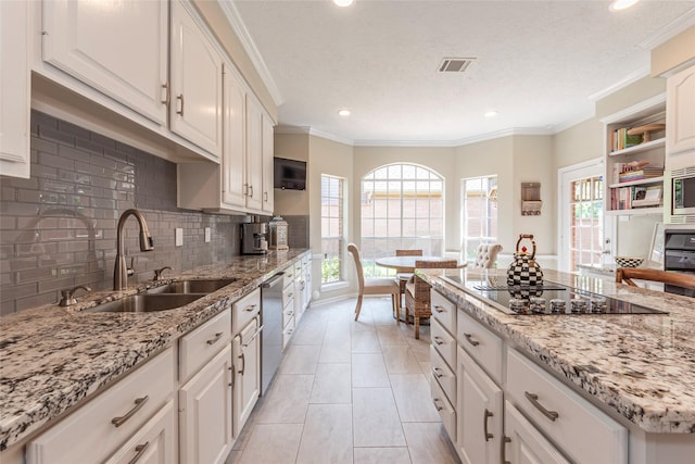 1907 Garden Fern Ct, Houston, TX 77062 - kitchen with stainless steel appliances, white cabinets, tasteful backsplash, recessed lighting, and light stone countertops