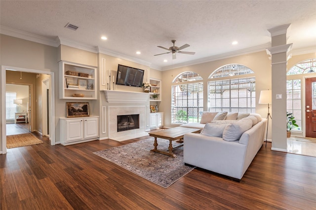1907 Garden Fern Ct, Houston, TX 77062 - living area featuring dark wood finished floors, a premium fireplace, ornamental molding, a ceiling fan, and a textured ceiling
