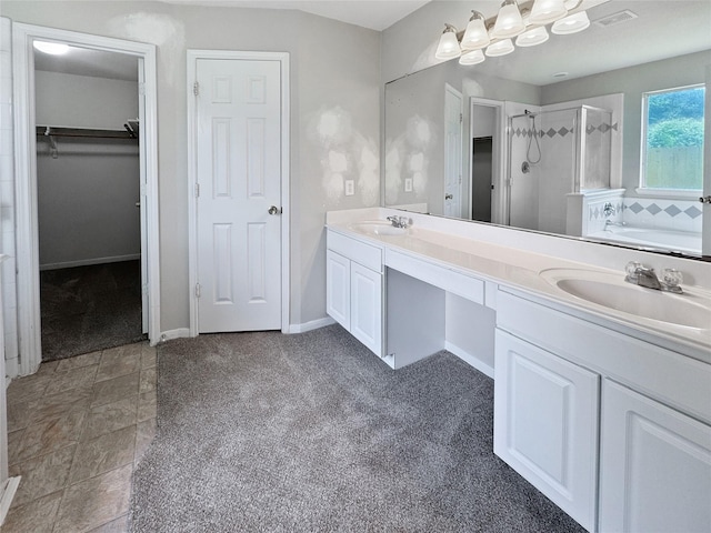 19327 Harvest Stream Way, Houston, TX 77084 - bathroom featuring a stall shower, double vanity, carpet flooring, a bath, and a spacious closet