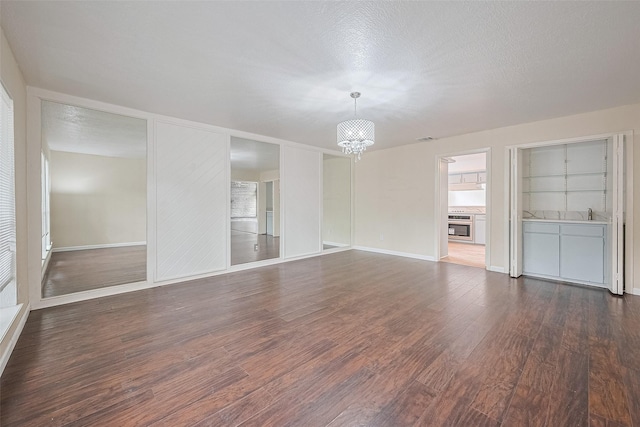 2107 Shadowbriar Dr, Houston, TX 77077 - spare room with a chandelier, dark wood finished floors, and a fireplace