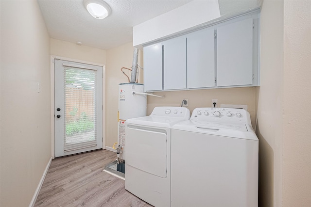 2107 Shadowbriar Dr, Houston, TX 77077 - washroom featuring cabinet space, washing machine and clothes dryer, gas water heater, and light wood-type flooring