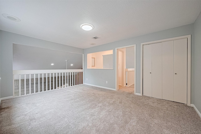 2107 Shadowbriar Dr, Houston, TX 77077 - unfurnished bedroom with carpet floors, a closet, a textured ceiling, and connected bathroom