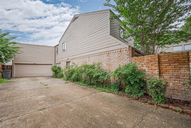 2107 Shadowbriar Dr, Houston, TX 77077 - view of side of property with brick siding and concrete driveway