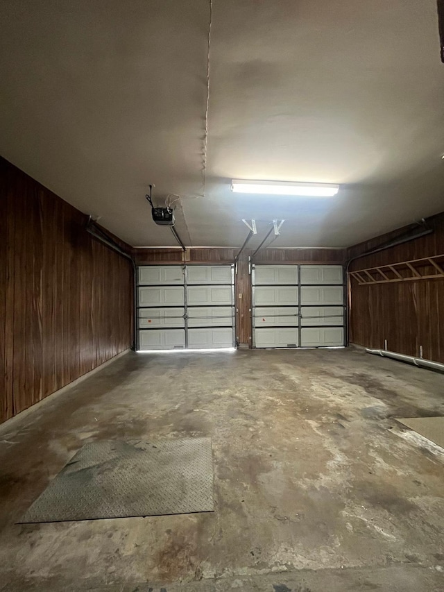 7541 Werner St, Houston, TX 77037 - garage featuring wooden walls and a garage door opener