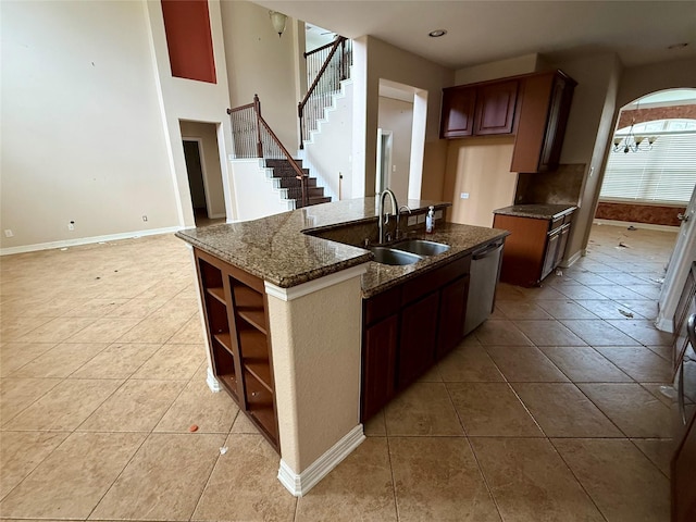 12503 Pepper Creek Ln, Pearland, TX 77584 - kitchen featuring stainless steel dishwasher, light tile patterned floors, open shelves, dark stone counters, and recessed lighting