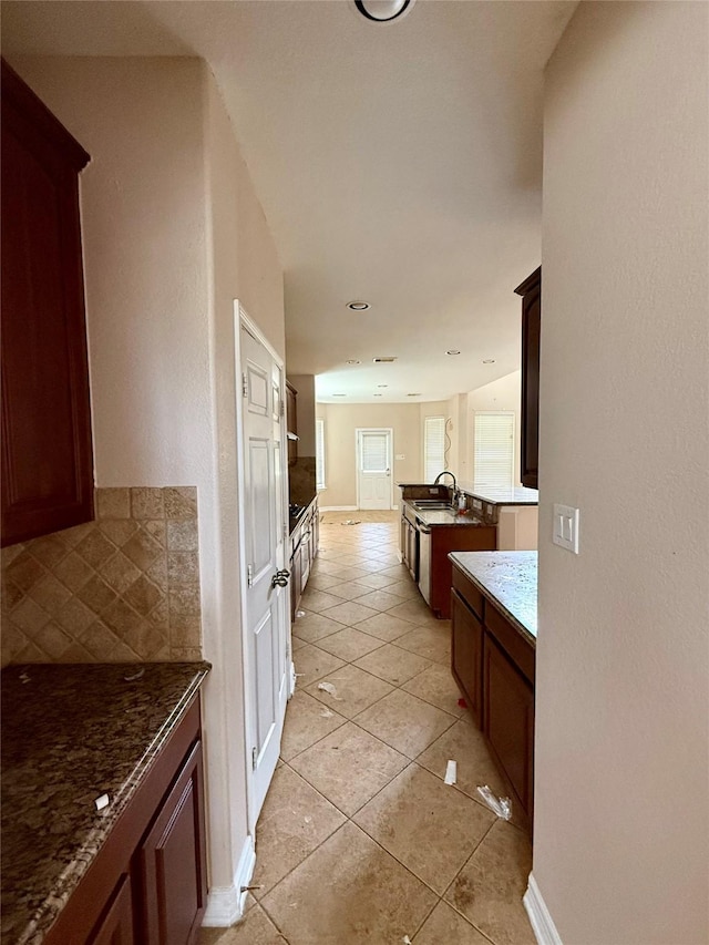 12503 Pepper Creek Ln, Pearland, TX 77584 - kitchen with decorative backsplash and light tile patterned floors