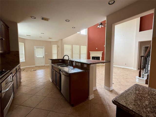 12503 Pepper Creek Ln, Pearland, TX 77584 - kitchen featuring oven, light tile patterned floors, a ceiling fan, stainless steel dishwasher, and recessed lighting