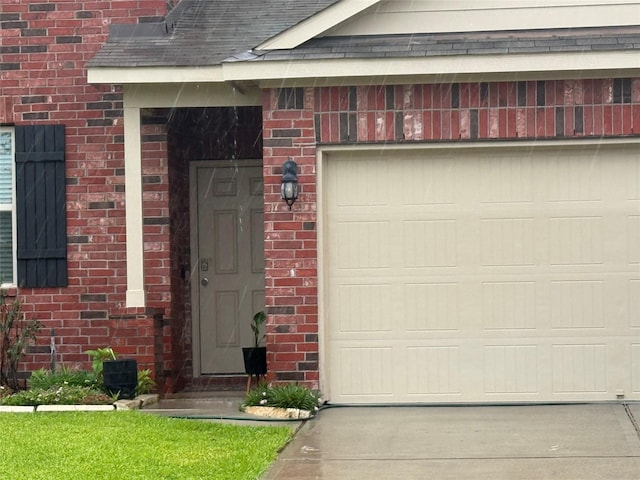 6106 Yesenia St, Katy, TX 77449 - view of exterior entry with brick siding, concrete driveway, and a garage