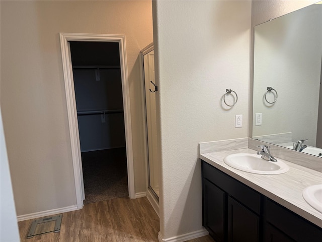 6106 Yesenia St, Katy, TX 77449 - full bath featuring a stall shower, wood finished floors, double vanity, and a spacious closet