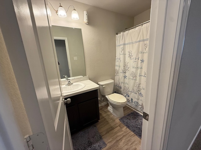 6106 Yesenia St, Katy, TX 77449 - full bathroom featuring wood finished floors, vanity, a textured wall, and curtained shower