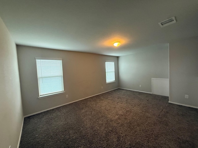 6106 Yesenia St, Katy, TX 77449 - spare room featuring dark carpet and baseboards