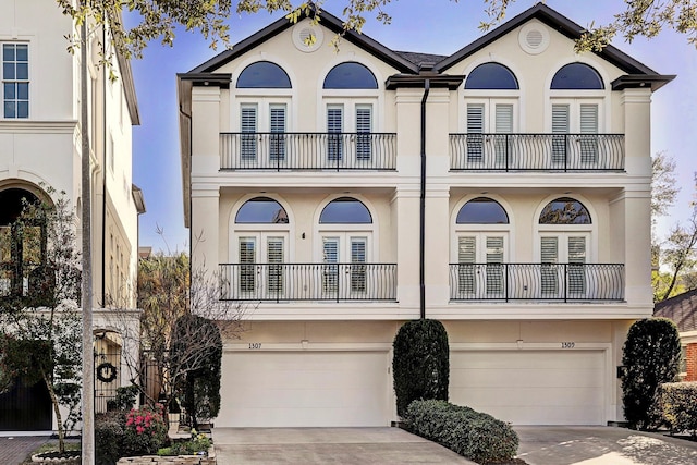 1307 W Bell St, Houston, TX 77019 - view of front of home with a balcony, french doors, stucco siding, and an attached garage