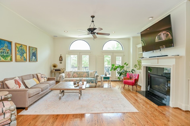 1307 W Bell St, Houston, TX 77019 - living room featuring a ceiling fan, a tiled fireplace, wood finished floors, recessed lighting, and crown molding