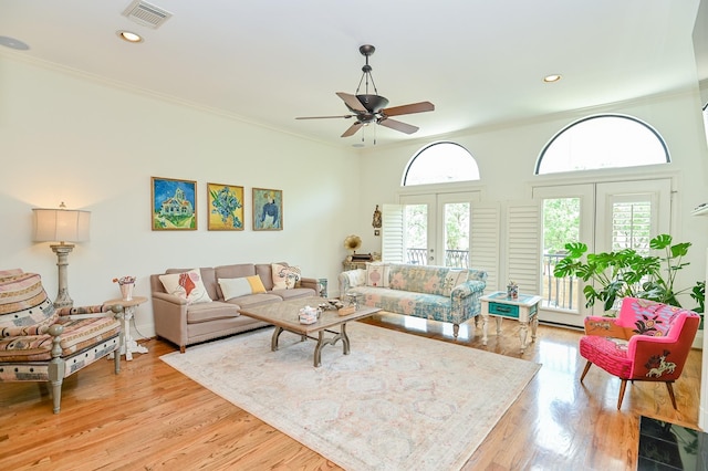 1307 W Bell St, Houston, TX 77019 - living area featuring healthy amount of natural light, a ceiling fan, ornamental molding, french doors, and light wood-style floors